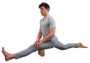 Front split resting on a yoga block